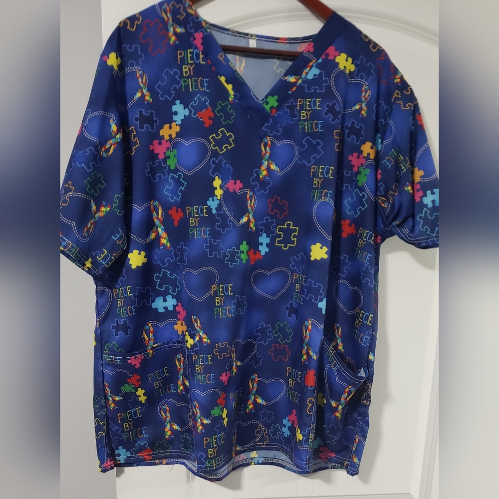 Pre owned Scrub top Plus size 2x, navy blue with puzzle pieces scattered.